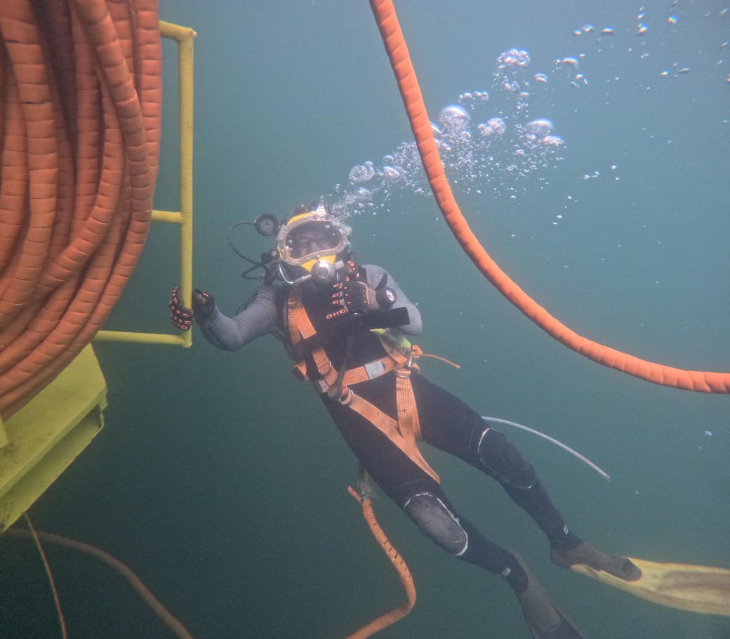 Commercial diver beside a submerged structure during an Atlas operation.