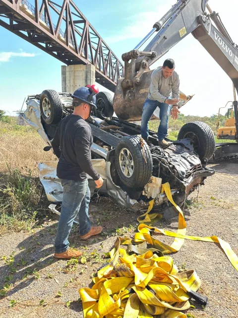 Atlas team beside a vehicle recovered from the water.